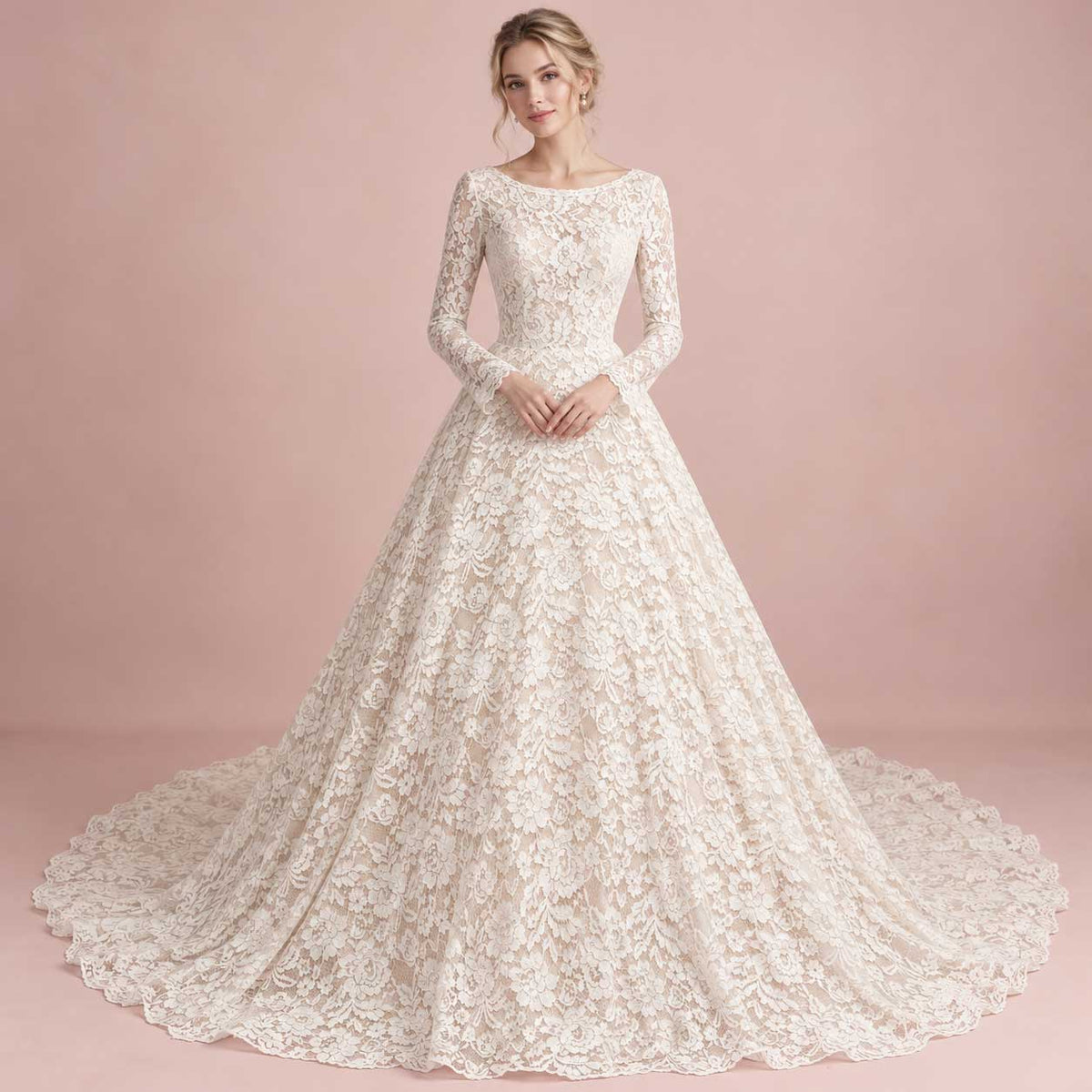 A woman modeling a long-sleeve lace ball gown with a full skirt and train against a soft pink studio backdrop.