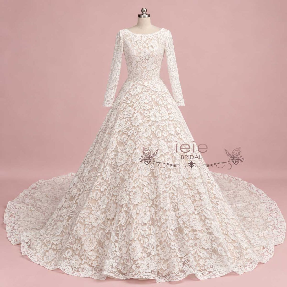 An ivory lace ball gown wedding dress with long sleeves and a full skirt, displayed on a mannequin against a solid pink studio background. The brand name 'leie BRIDAL' is watermarked across the center.