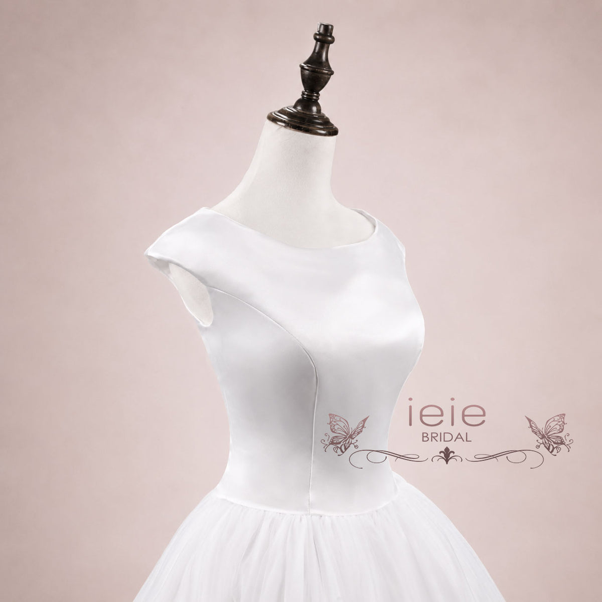 Close up of 1950s style satin bodice and voluminous tulle bridal skirt