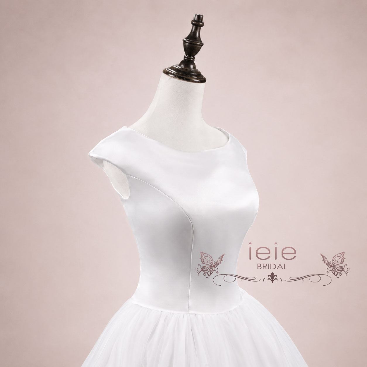 Close up of 1950s style satin bodice and voluminous tulle bridal skirt